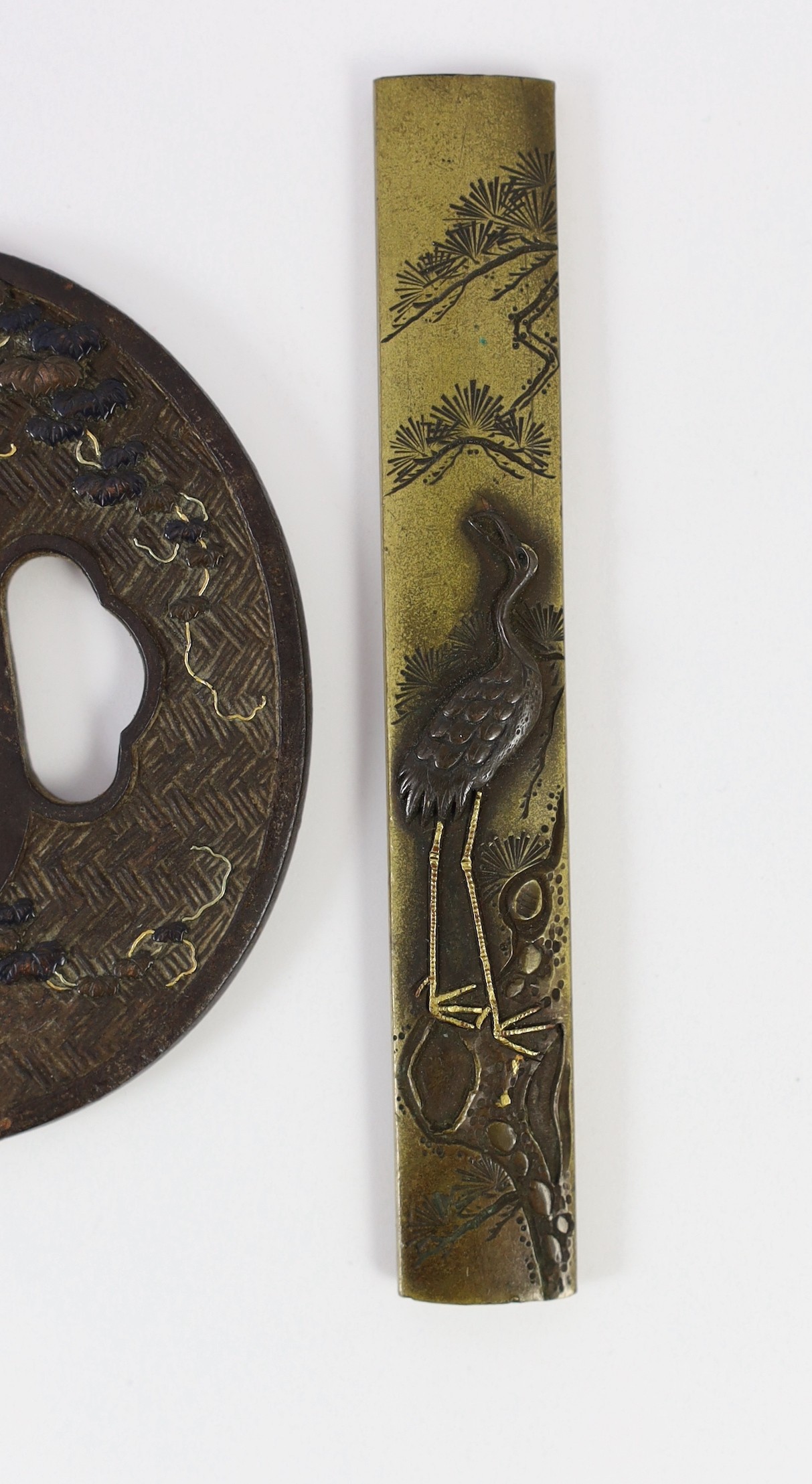 A group of Japanese bronze, iron and mixed metal tsuba and a kozuka knife handle, 19th century